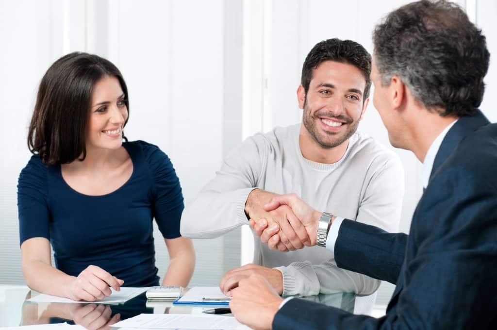 Couple meeting with professional to talk numbers