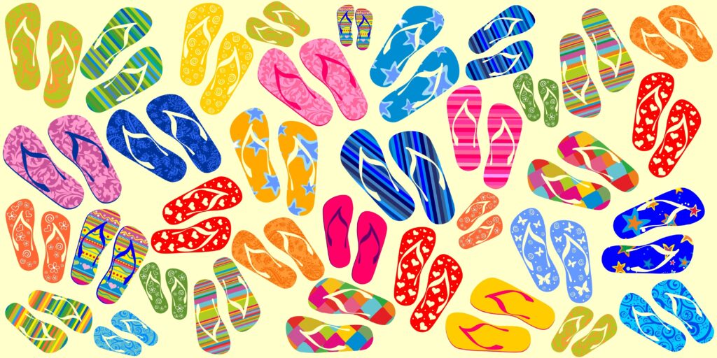 A colorful assortment of flip-flops with various patterns and sizes scattered on a light yellow background. The designs include stripes, florals, polka dots, and animal prints in bright, vibrant colors.