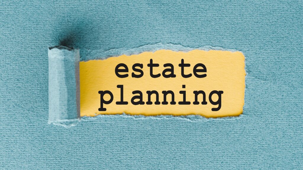 A piece of blue paper is torn open, revealing the words estate planning in bold black letters on a yellow background underneath.