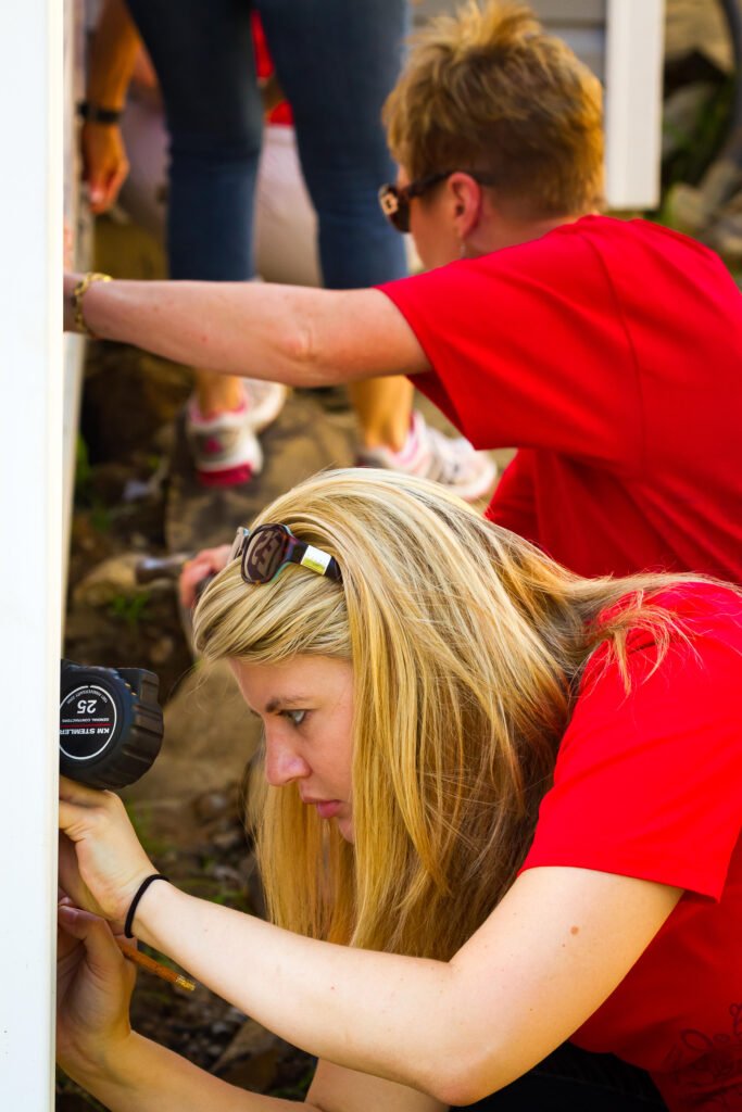 Michelle Floyd Habitat takes measurements for Habitat build