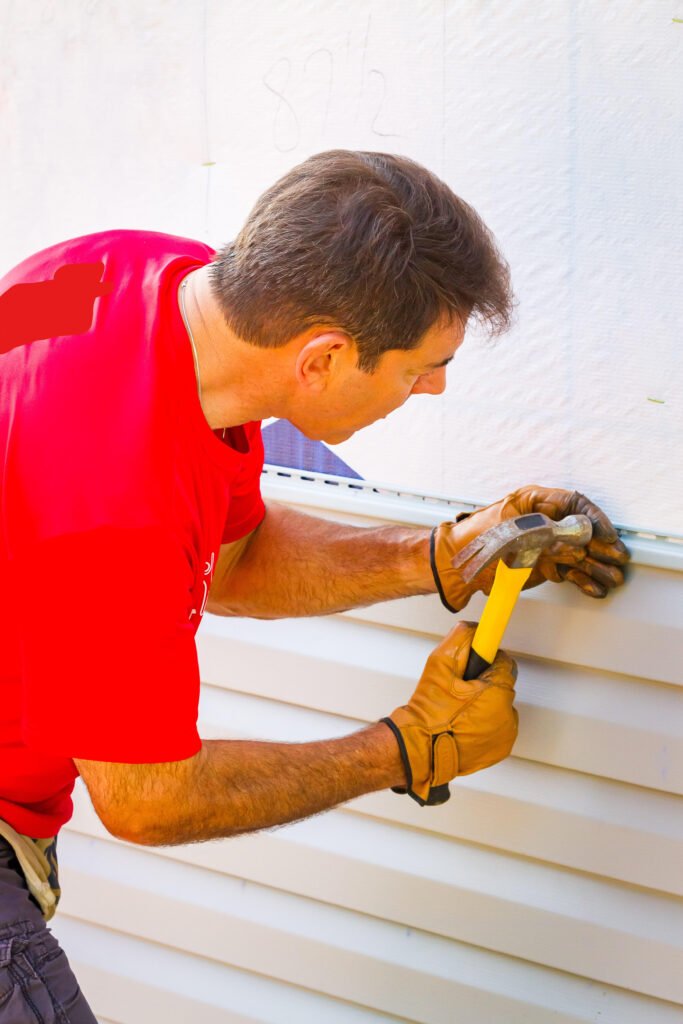 Axiom team installs siding to help Habitat for Humanity