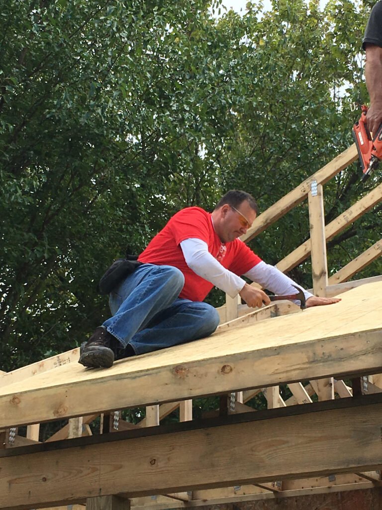 Axiom team nails down roof to help Habitat